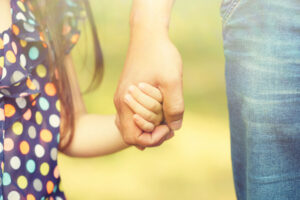 father holding daughter's hand